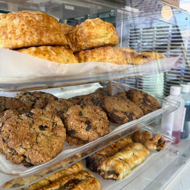 Counter display of scones, cookies and sausage rolls